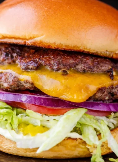 Delicious homemade Juicy Smash Burger cooked to perfection with crispy edges.