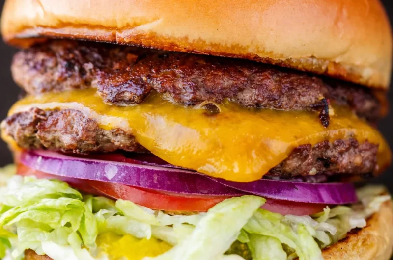 Delicious homemade Juicy Smash Burger cooked to perfection with crispy edges.