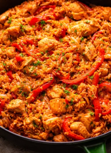 One pan chicken and rice dinner ready in 30 minutes with colorful vegetables.
