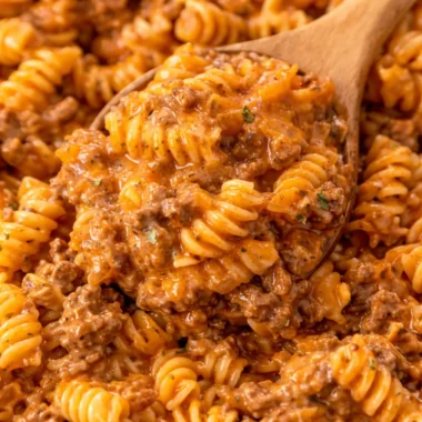 Easy 30 Minute One Pan Pasta With Ground Beef topped with cheese in a skillet.