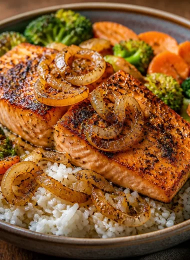 Crispy Garlic Pepper Salmon served in a vibrant rice bowl with vegetables.