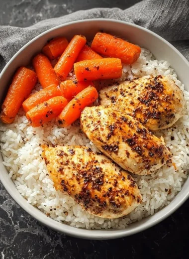 Delicious black pepper chicken breast served with rice and glazed carrots