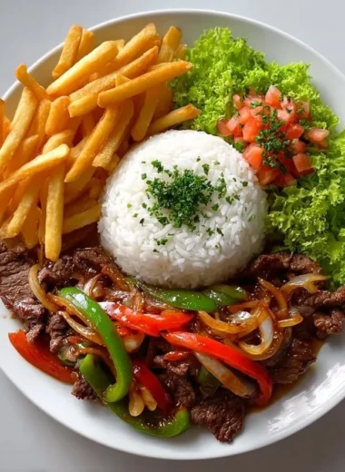 Crispy beef stir-fry plate with rice, fries, and salad ready to enjoy