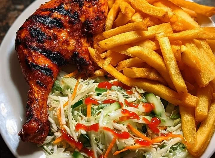 Crispy fries served with flame-grilled chicken leg and fresh salad