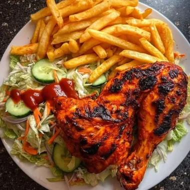 Delicious flame-grilled chicken leg quarters served with fries and salad