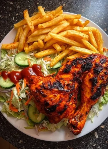 Delicious flame-grilled chicken leg quarters served with fries and salad