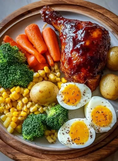 Smoky BBQ chicken leg quarter served with colorful veggies and fried eggs