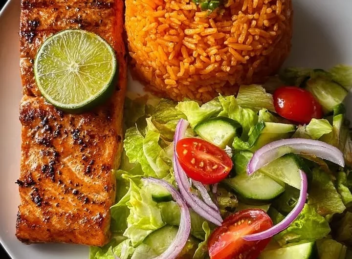 Zesty lime salmon served with Spanish rice and garden salad