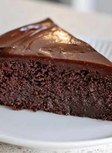 Slice of creamy French chocolate cake with rich chocolate frosting