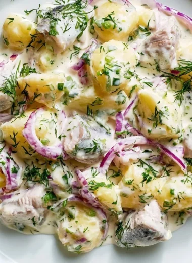 Delicious Matjesfilet Hausfrauenart served on a plate with garnish