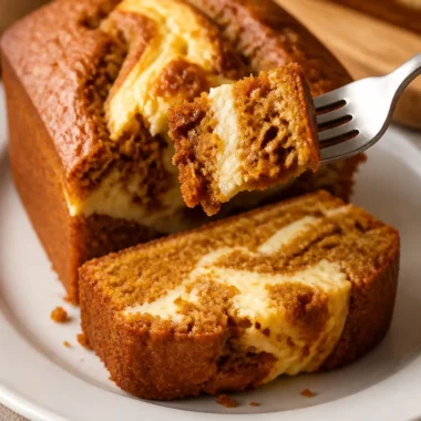 Cozy pumpkin bread with cream cheese swirl slice on a rustic table