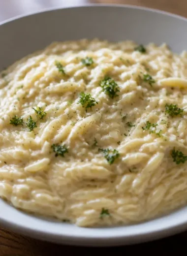 Creamy Garlic Parmesan Orzo served on a plate with herbs